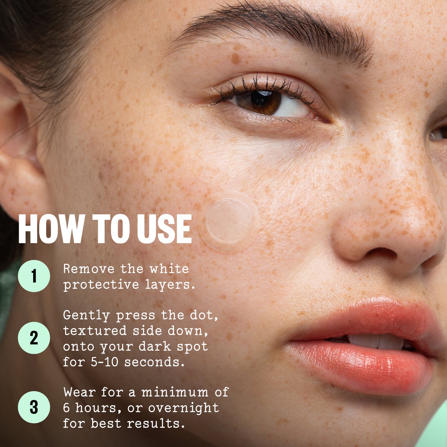 Close-up of a woman's face with skincare text and numbered steps overlaid on the left side, explaining how to use a dark spot treatment dot on the cheek.