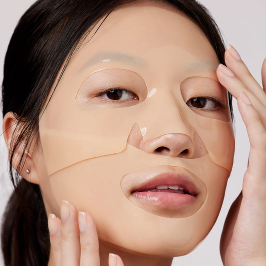 Woman wearing Peace Out Barrier Revitalizing & Renewing Overnight Recovery Mask with hands hover over face