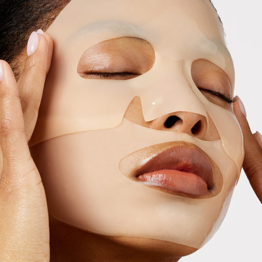 A woman gently presses Peace Out Barrier Revitalizing & Renewing Overnight Recovery Mask onto her face