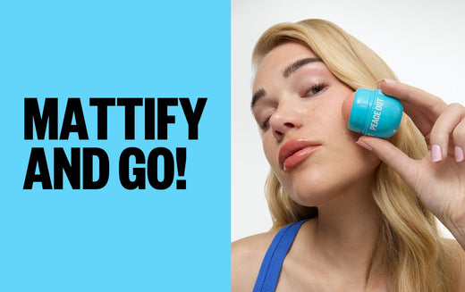 A woman in a blue tank top removes excess oil from her face with Peace Out's Oil Control Roller