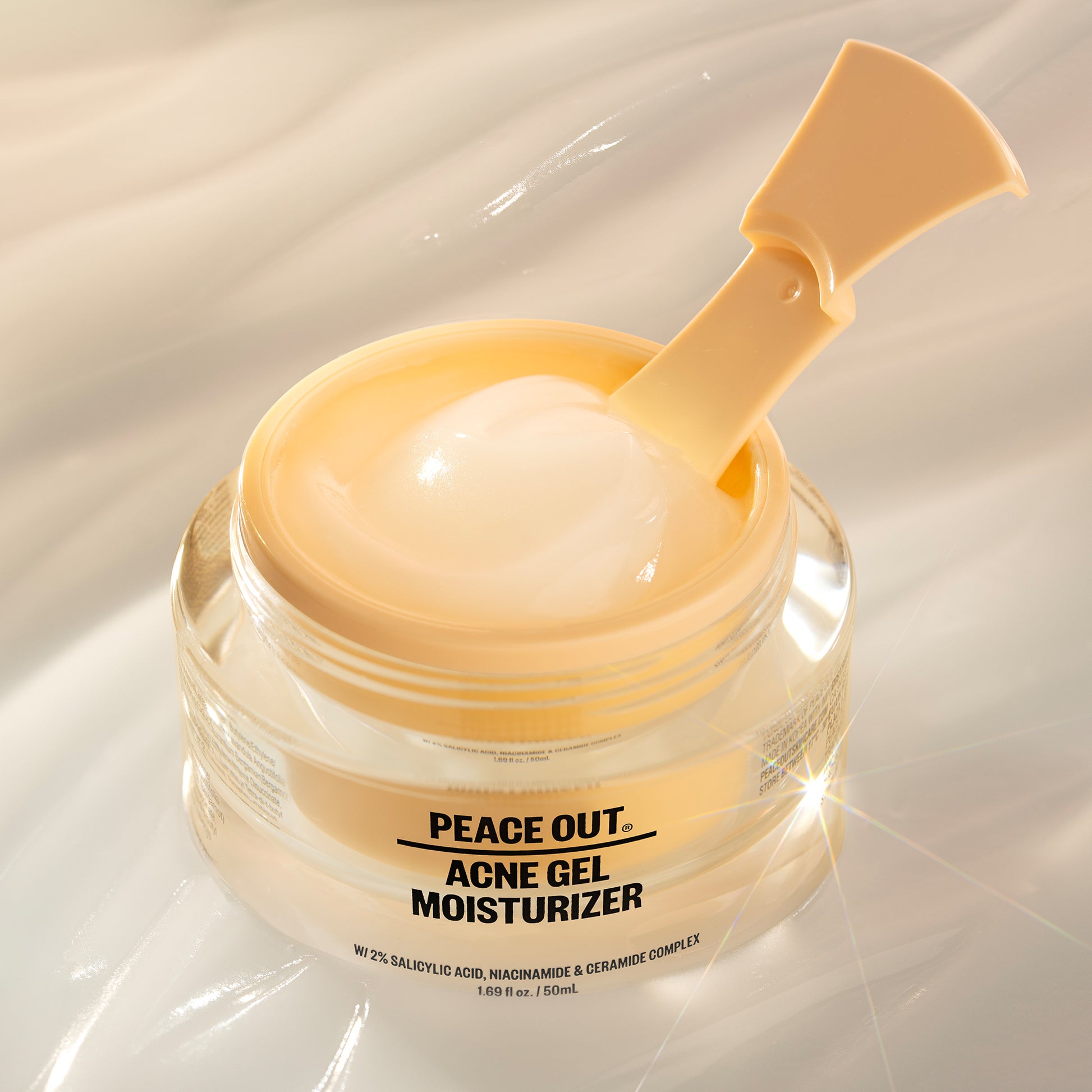 Peace Out Acne Gel Moisturizer with 2% Salicylic Acid with included spatula hover over the gel