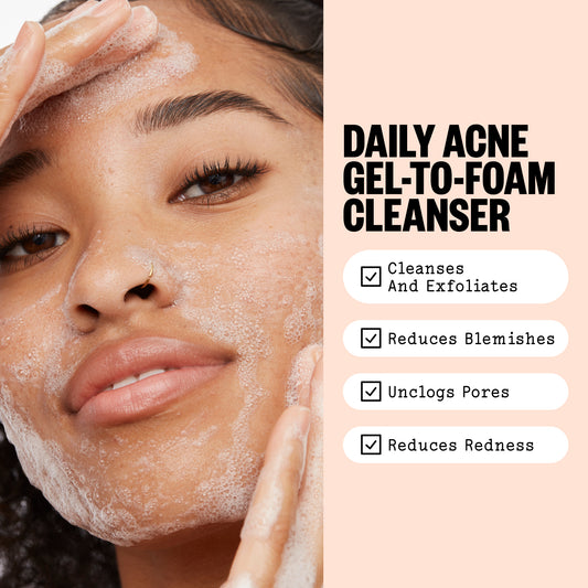 Close-up of a woman with foaming gel-to-foam facial cleanser on her face, next to text reading 'DAILY ACNE GEL-TO-FOAM CLEANSER' with benefits listed below.
