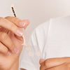 Man holds tweezers hover over Acne Healing Dots