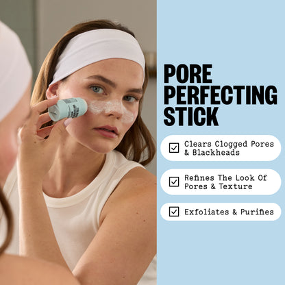 A woman applies Pore Perfecting Stick forehead and cheeks while looking into a mirror. The right side of the image has a light blue panel with the text 'PORE PERFECTING STICK' and three white rounded boxes listing benefits: clears clogged pores and blackheads, refines the look of pores and texture, and exfoliates and purifies.