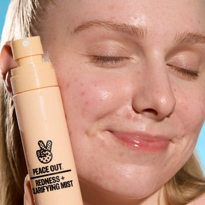 Person using Peace Out Redness + Clarifying Mist outdoors after a workout.