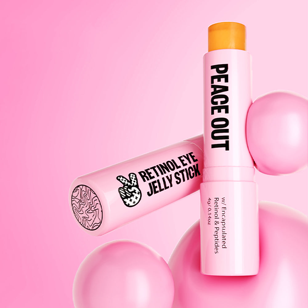 Peace Out Retinol Eye Jelly Stick atop pink bubbles