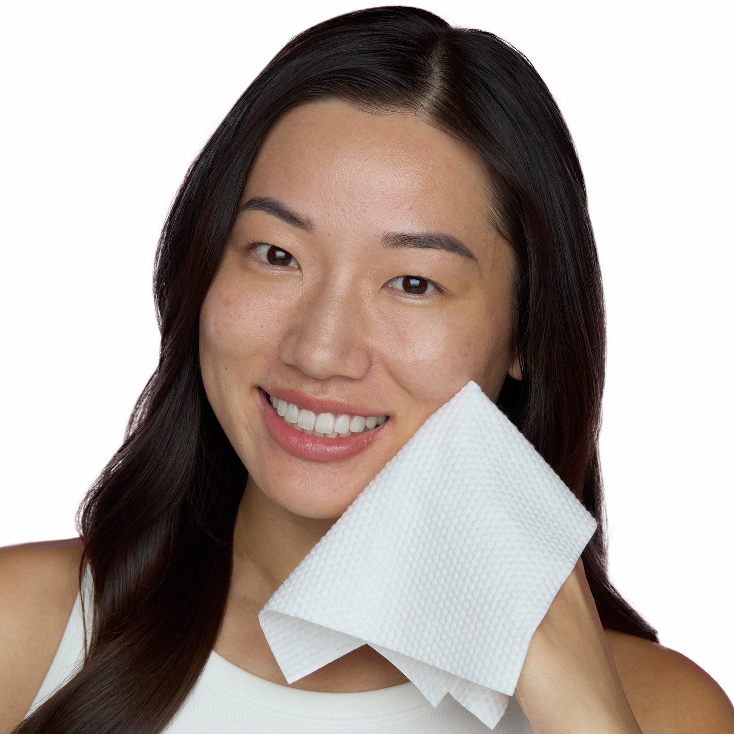 Woman with an antimicrobial silver-citrate-infused Silver Shield Face Towel by Peace Out on her face against a white background