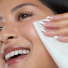 Close-up of a woman cleaning her face with an antimicrobial silver-citrate-infused Silver Shield Face Towel  - hover